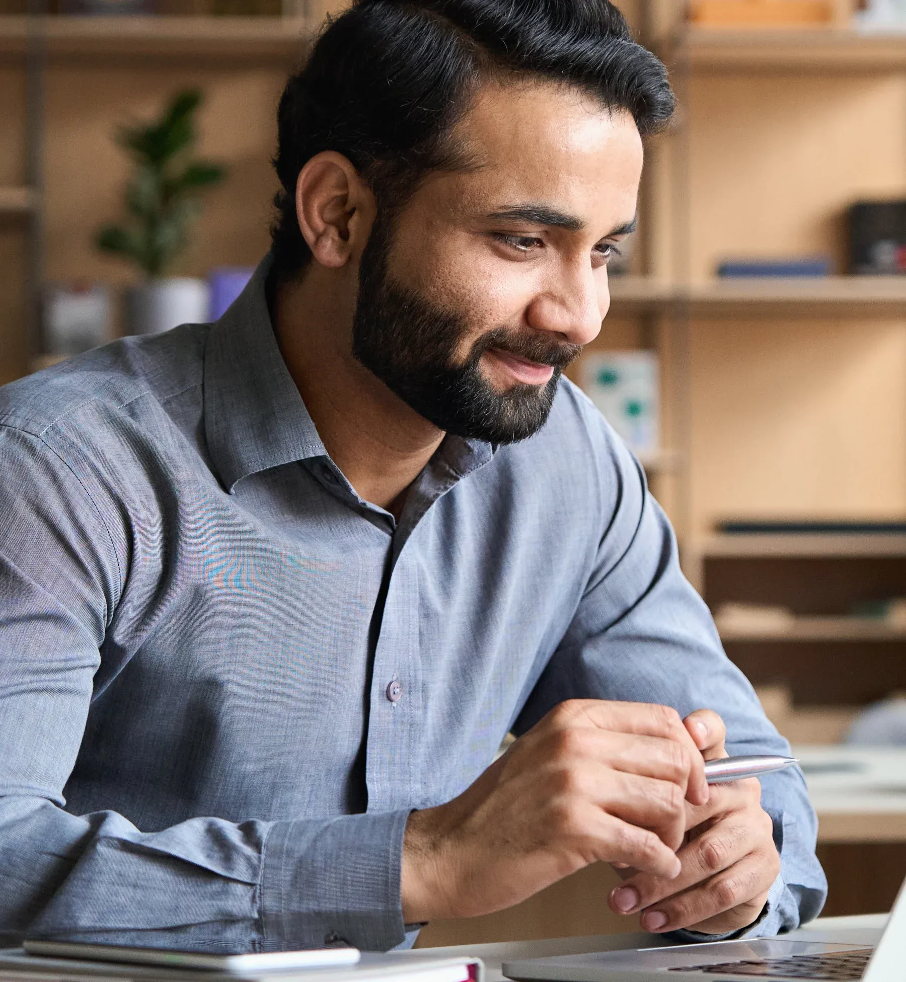 A business owner reviewing healthcare news on a laptop